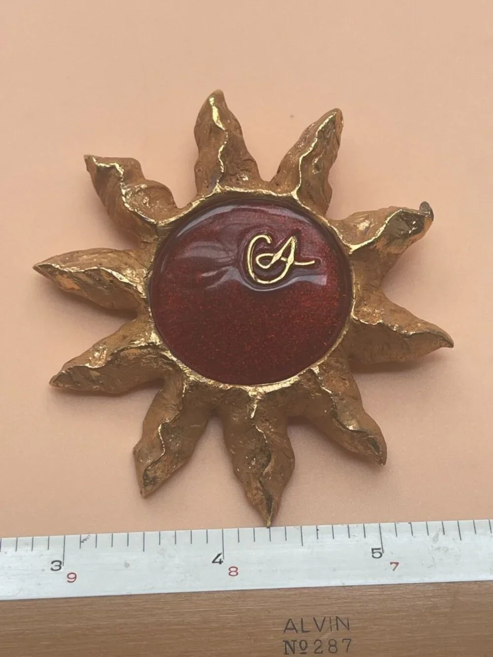 Christian Lacroix Gold-Tone Sun Brooch W/ Red Resin Center & Golden Logo